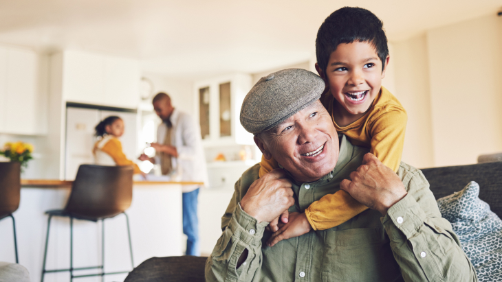 Life Insurance for Adults | Home, grandfather and boy relax, hug and happiness with love, family and quality time in the lounge.