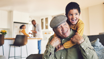Life Insurance for Adults | Home, grandfather and boy relax, hug and happiness with love, family and quality time in the lounge.