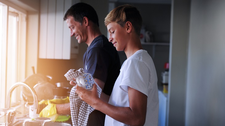 Cash Value Life Insurance – Father and son washing dishes together